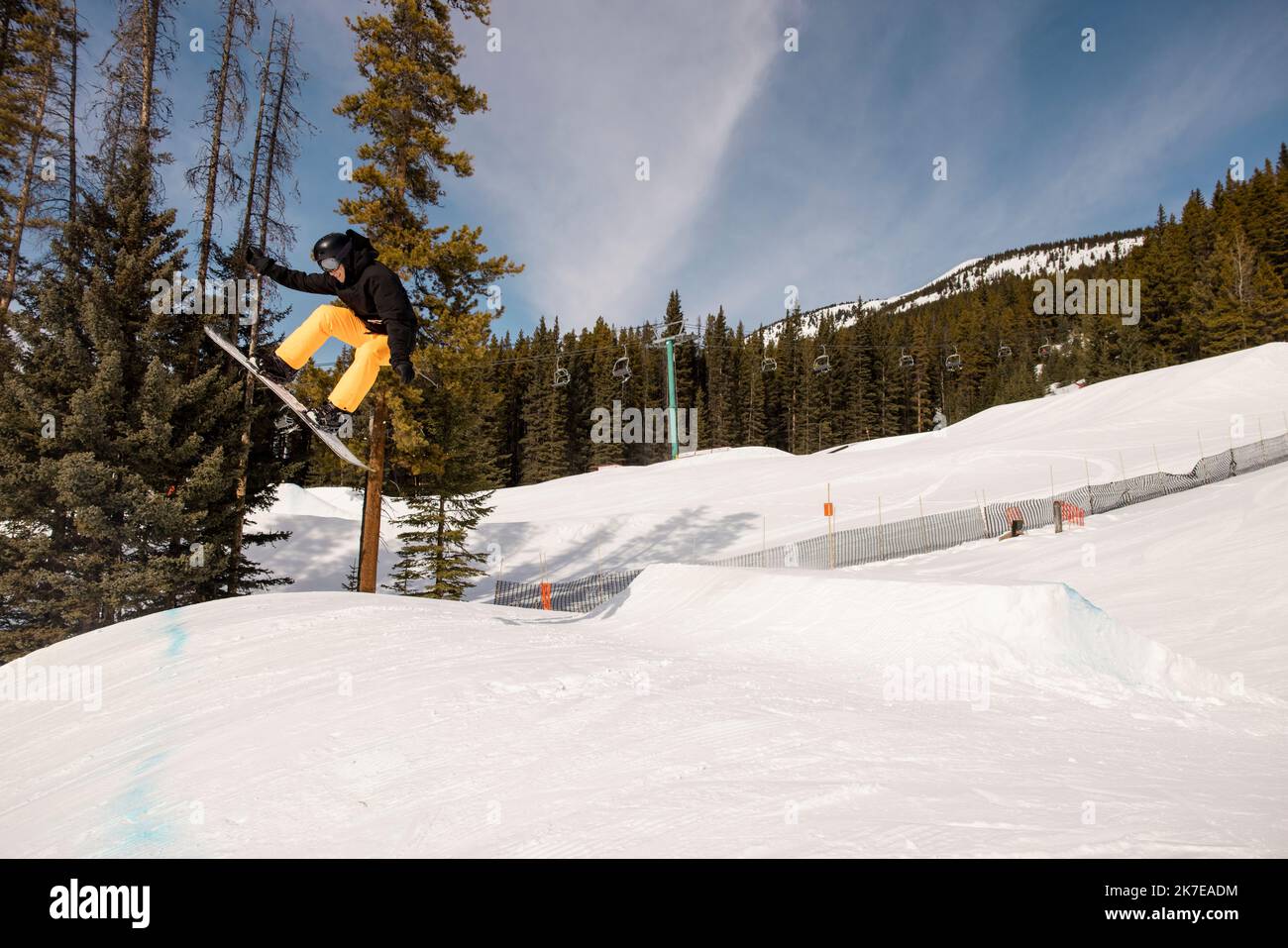 Man doing snowboard jump over sunny snowy mountain slope Stock Photo Alamy
