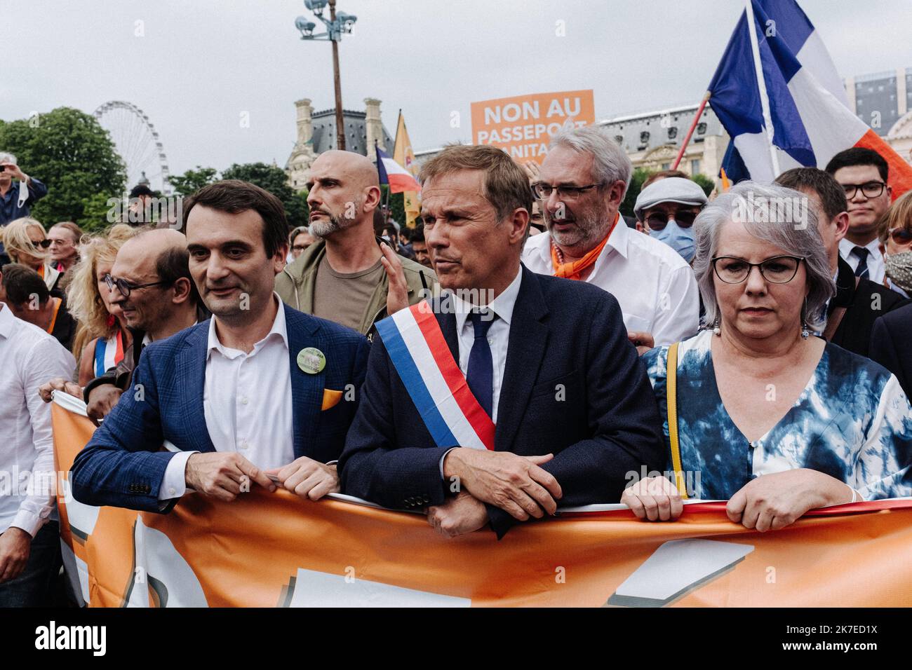 ©Jan Schmidt-Whitley/Le Pictorium/MAXPPP - Jan Schmidt-Whitley/Le Pictorium - 17/07/2021 - France / Ile-de-France / Paris - A la tete de la manifestation contre le passeport sanitaire, de droite a gauche: Jacline Mouraud (ancienne gilet jaune), Nicolas Dupont-Aignan (president de Debout la France) et Florian Philippot. A Paris, a l'initiative du president des Patriotes Florian Philippot (ancien numero 2 du Rassemblement national), etait organisee une manifestation contre le pass sanitaire qui a rassemble plusieurs milliers de manifestants. Elle a relie la place du Palais Royal dans le Ier arro Stock Photo