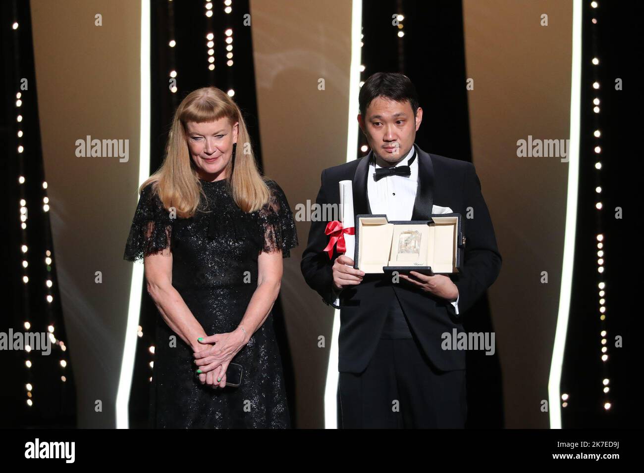 ©PHOTOPQR/NICE MATIN/Patrice Lapoirie ; Cannes ; 17/07/2021 ; Japanese director Ryusuke Hamaguchi poses on stage with his trophy after he was awarded with the Best Screenplay prize for the film 'Drive My Car' during the closing ceremony of the 74th edition of the Cannes Film Festival in Cannes, southern France, on July 17, 2021. The 74th Cannes International Film Festival, in France. Stock Photo