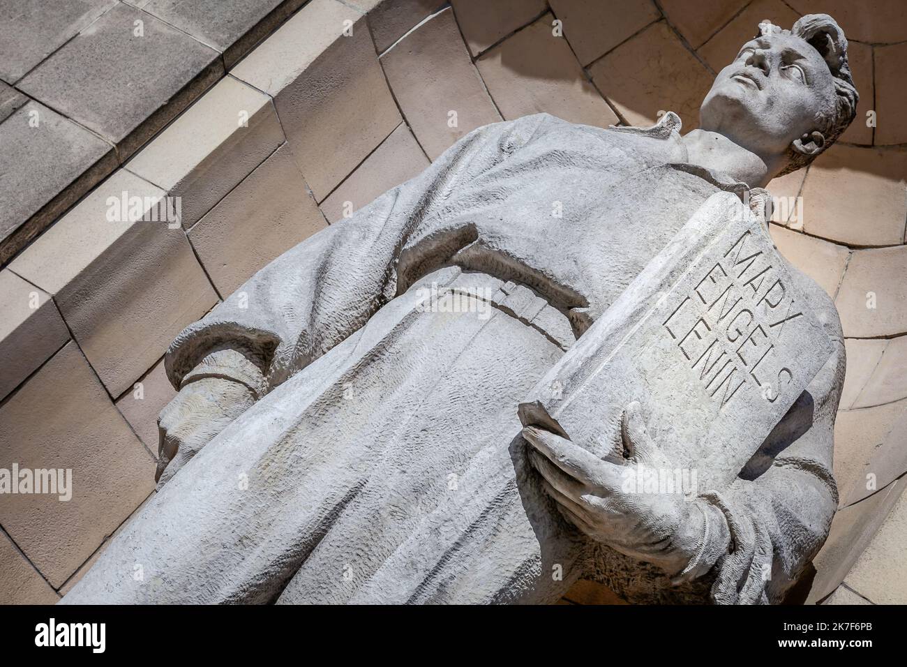 Worker with Marx, Engels and Lenin book in Warsaw, Poland Stock Photo