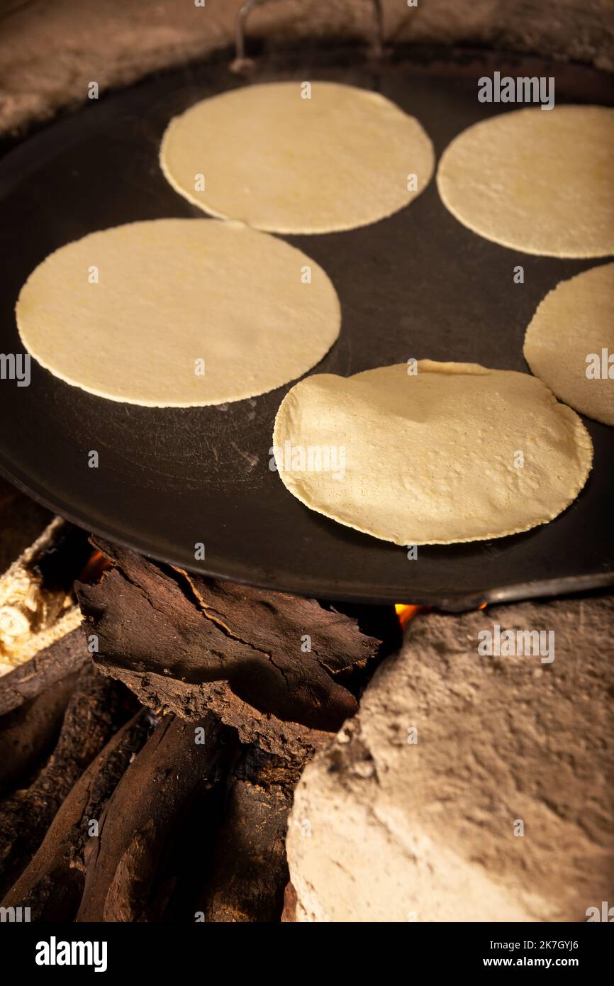 Handmade corn tortillas cooked in a traditional rustic wood stove