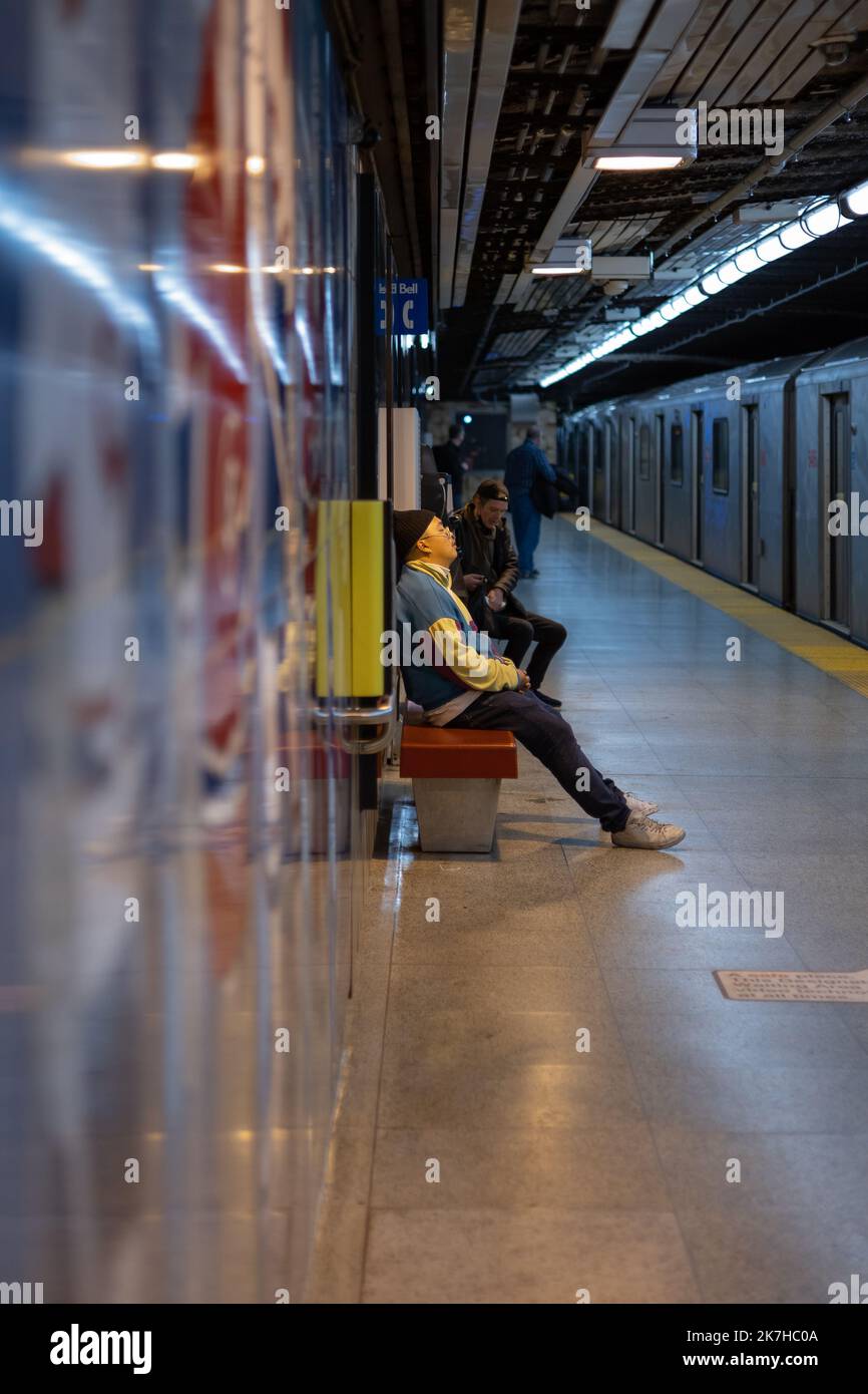 Man sleeping on subway station bench, Toronto, Ontario, Canada Stock Photo