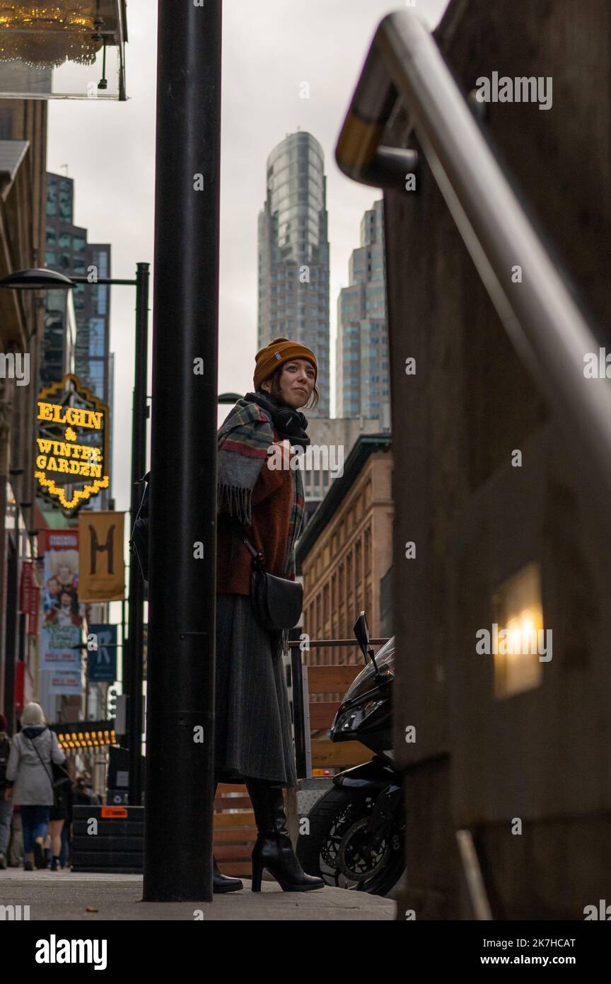 Fashionable woman waiting to cross the street in Toronto, Ontario, Canada. Stock Photo