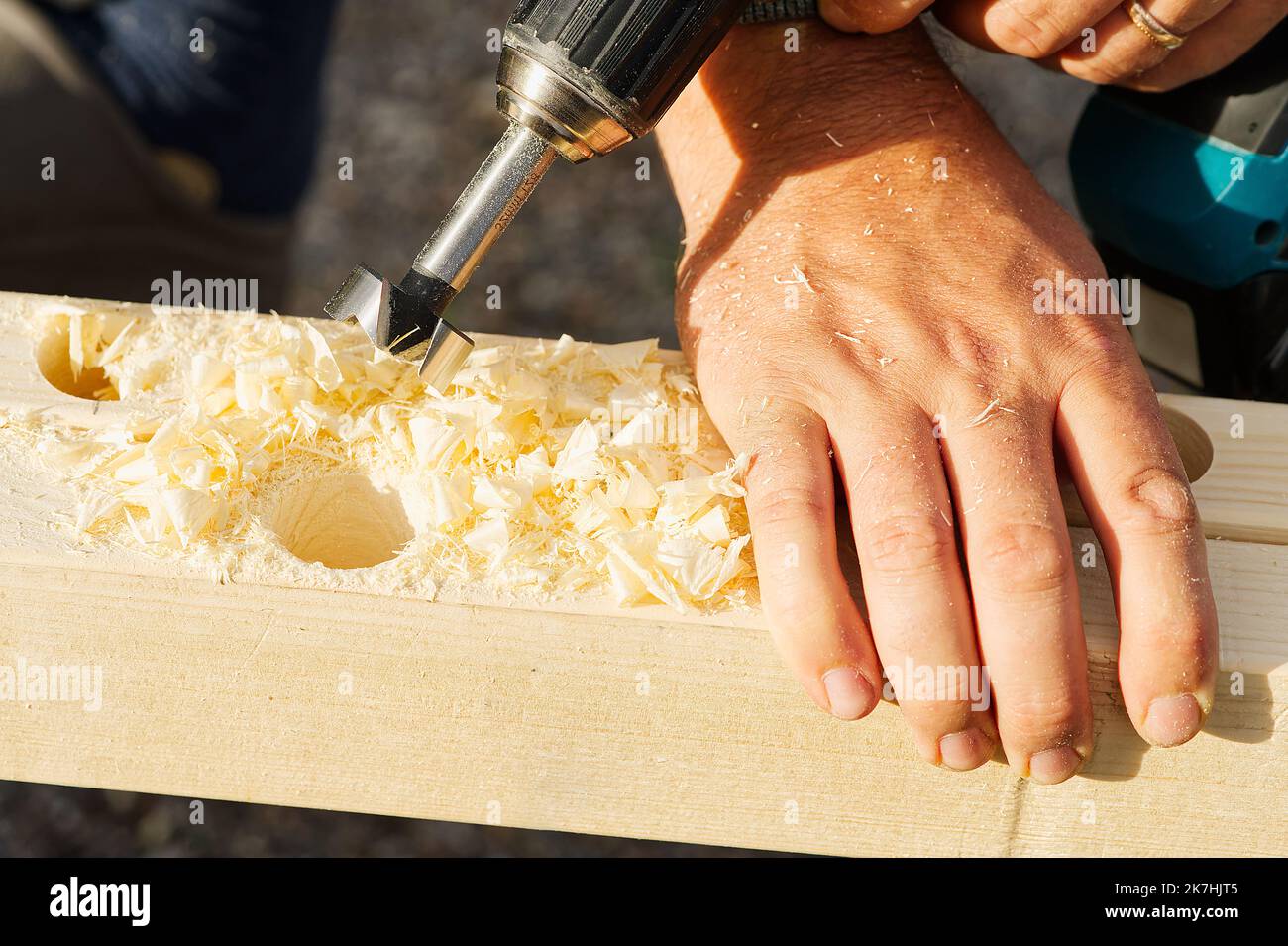 Drilling a hole in a wooden beam with a drill Stock Photo Alamy