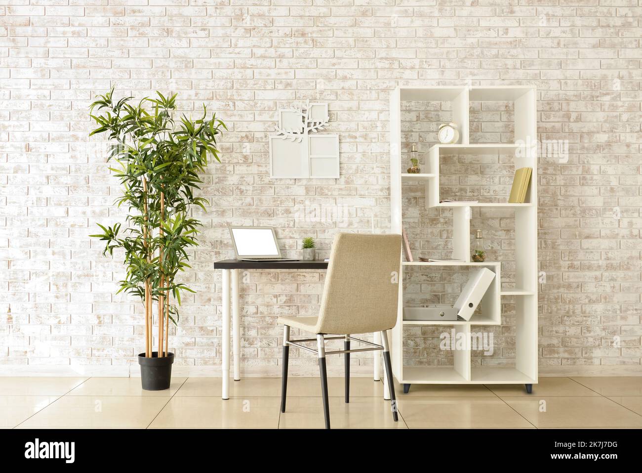 Cozy interior of modern workplace with laptop and family tree photo ...