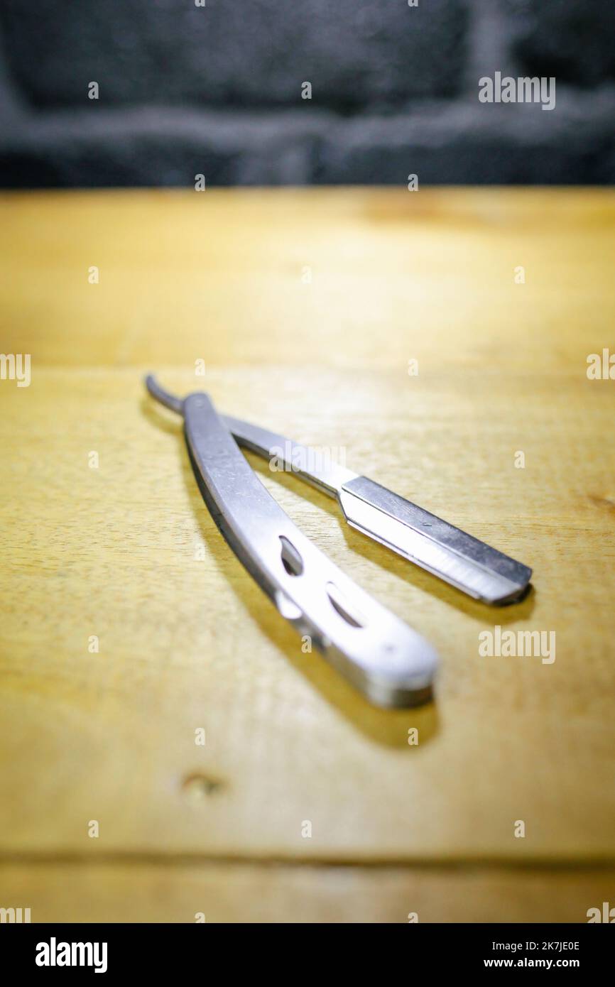 Open old dangerous razor on a wooden background. isolated, blade Stock