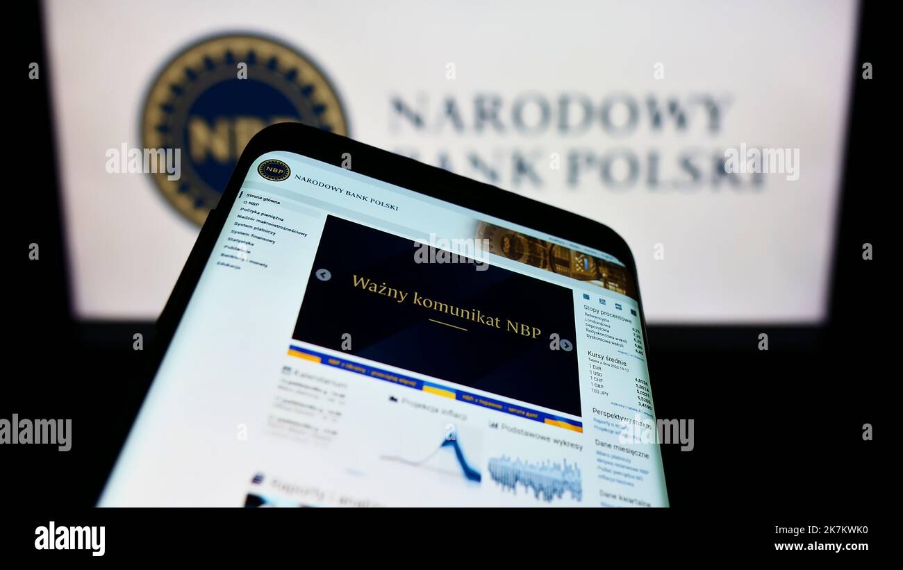 Mobile phone with website of Polish central bank Narodowy Bank Polski (NBP) on screen in front of logo. Focus on top-left of phone display. Stock Photo