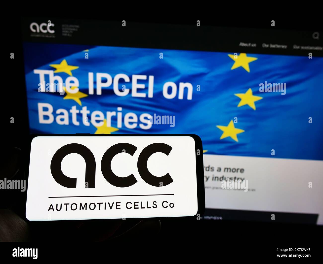 Person holding cellphone with logo of French Automotive Cells Company SE (ACC) on screen in front of business webpage. Focus on phone display. Stock Photo