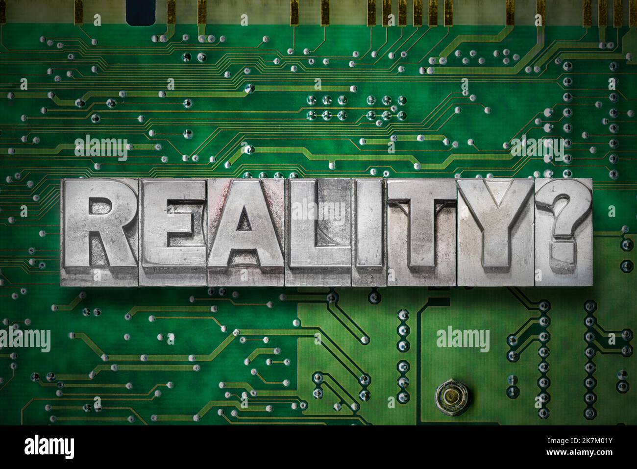 reality question made from metallic letterpress blocks on the pc board background Stock Photo