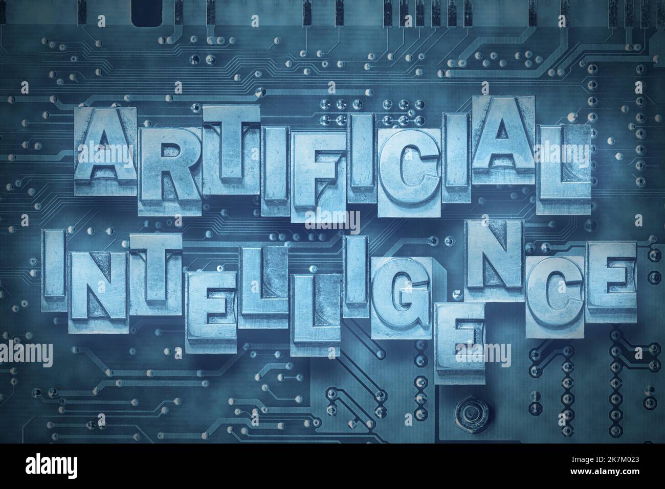 artificial intelligence phrase made from metallic letterpress blocks on the pc board background Stock Photo