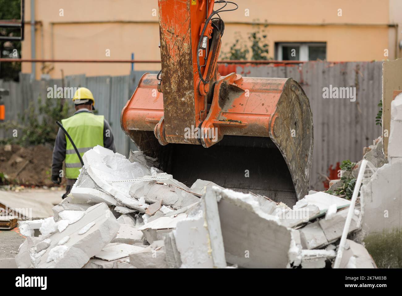 Details with an excavator bucket (scoop) used to demolish an AAC small building. Stock Photo