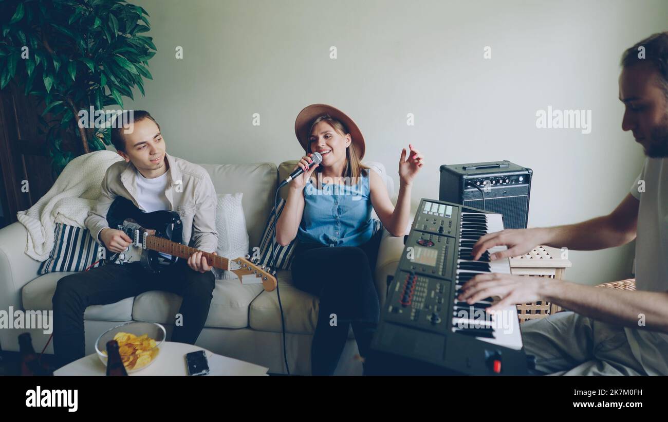 Cheerful friends young musicians are practising in the house, female