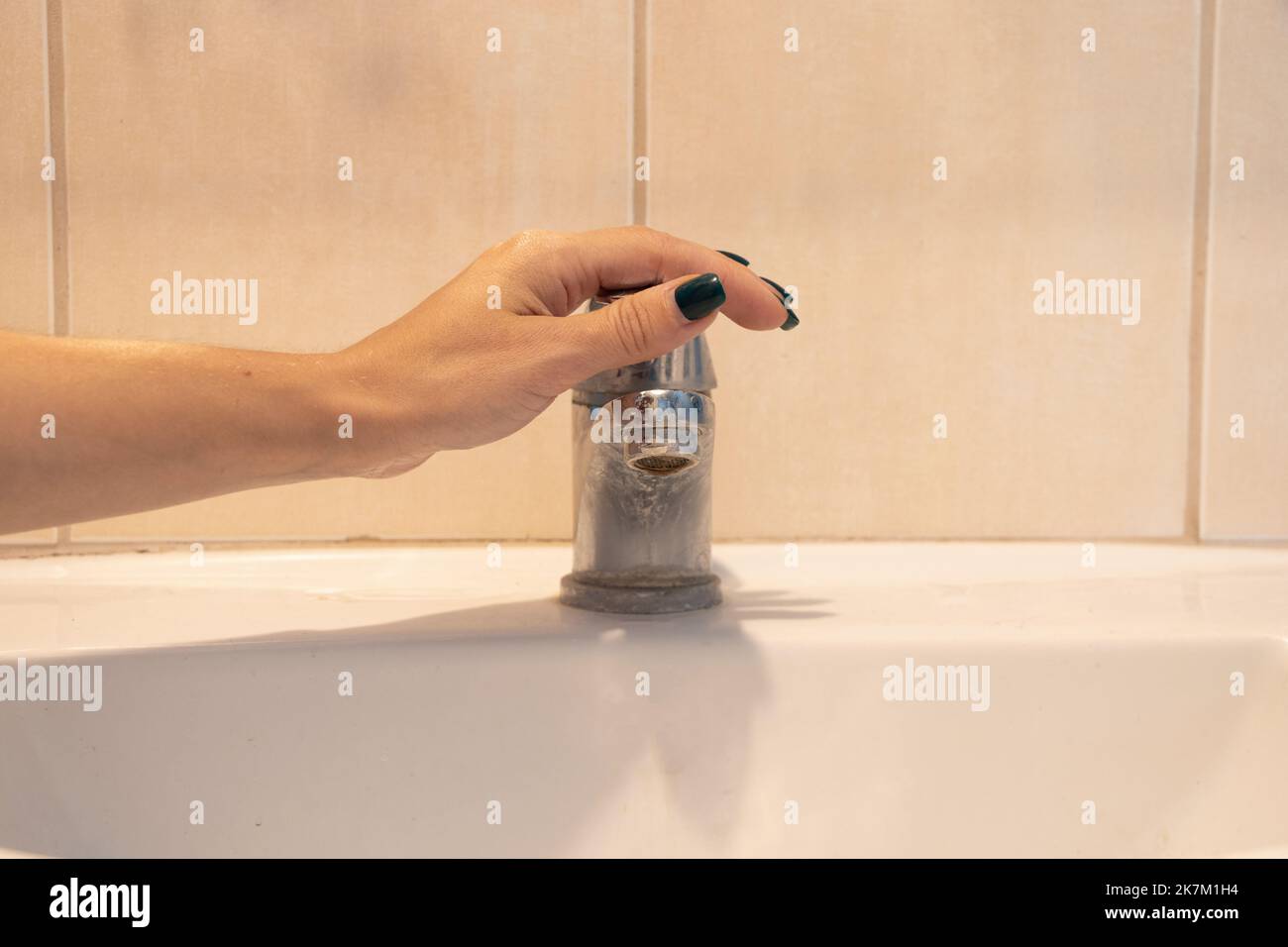 female hands in the sink under the tap, wash hands, clean hands, bathroom, sink Stock Photo