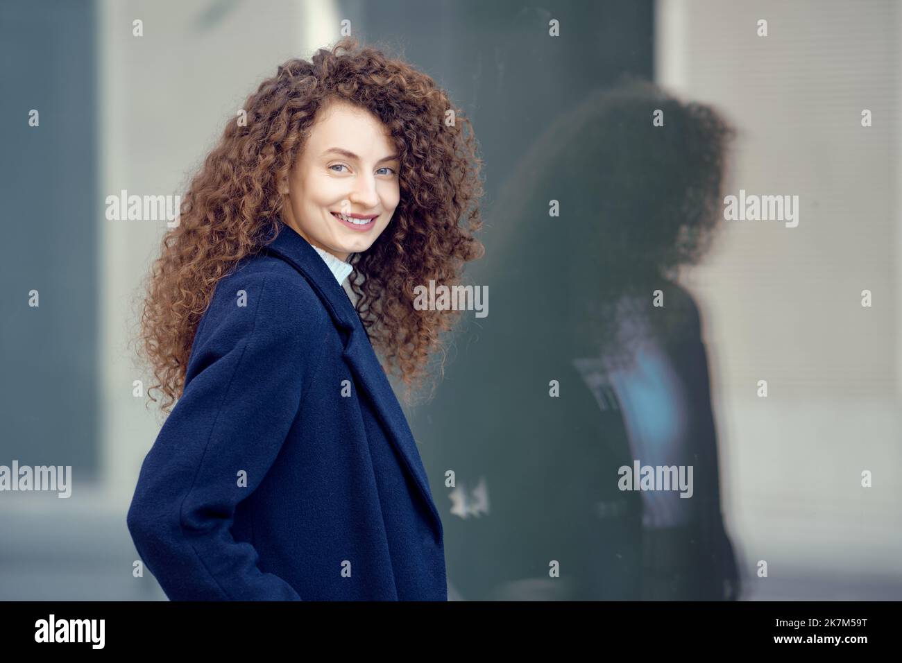 Happy smiling young woman on the street Stock Photo