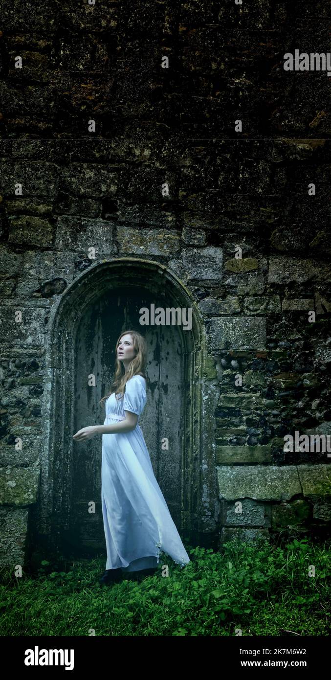 pale ghostly woman in front of old church door Stock Photo