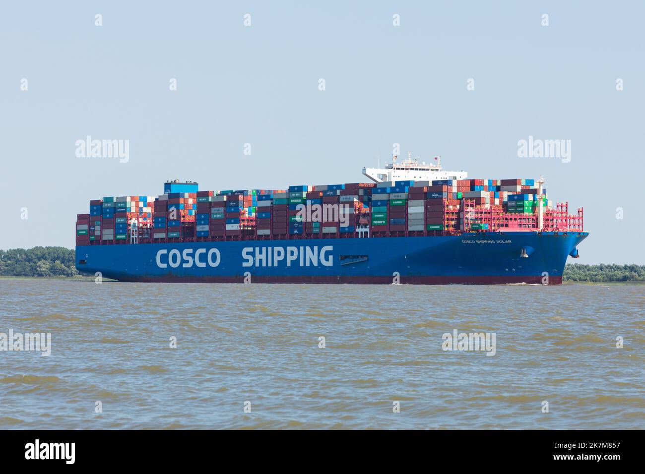 Container Ship COSCO SHIPPING SOLAR, built in 2019 and sailing under the flag of Hong Kong on Elbe river heading to Hamburg. Stock Photo