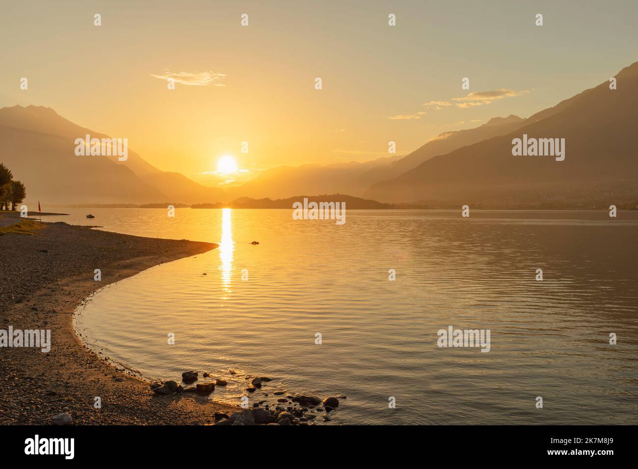 Vibrant sunrise at Domaso beach, Lake Como, looking to Valtellina valley Stock Photo