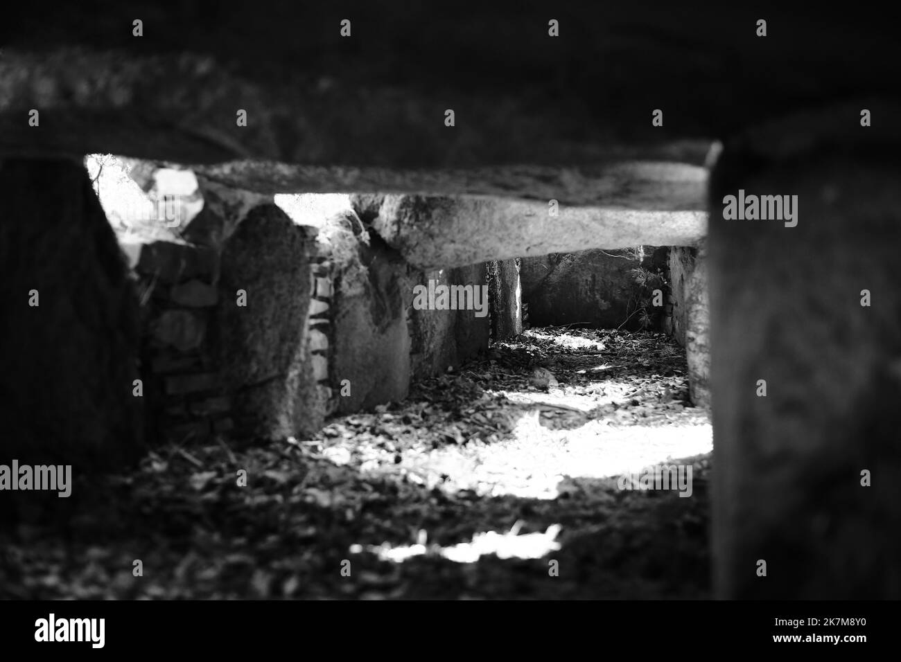 Black and white image of corridor in the prehistoric dolmen Kuechentannen in Germany. Stock Photo