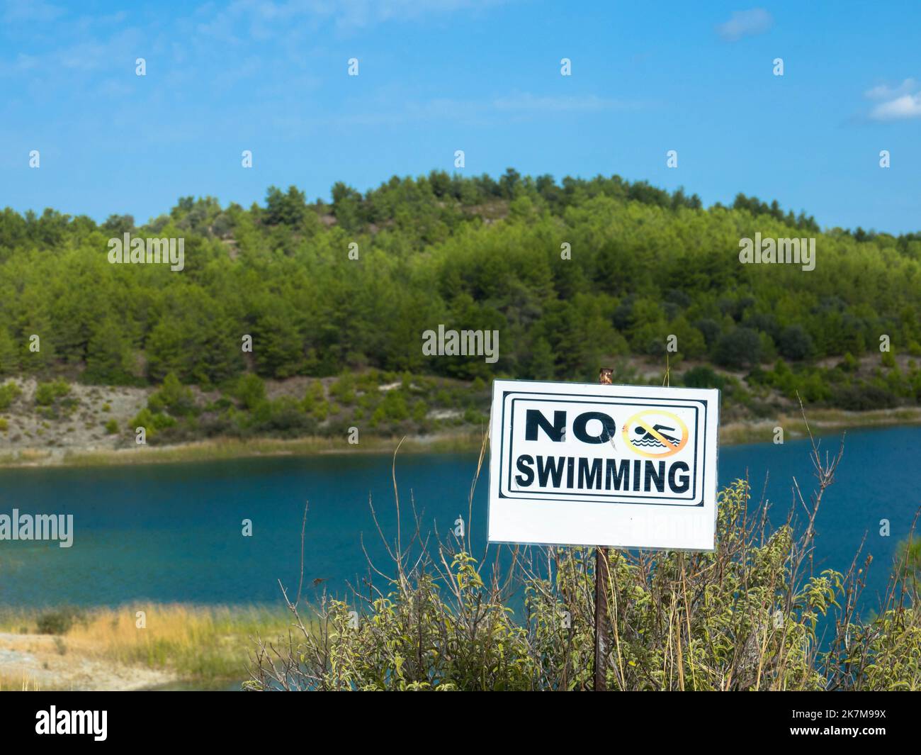 Panoramic view of Gadoura Dam. No swimming sign in the foreground. Rhodes, Greece. Stock Photo