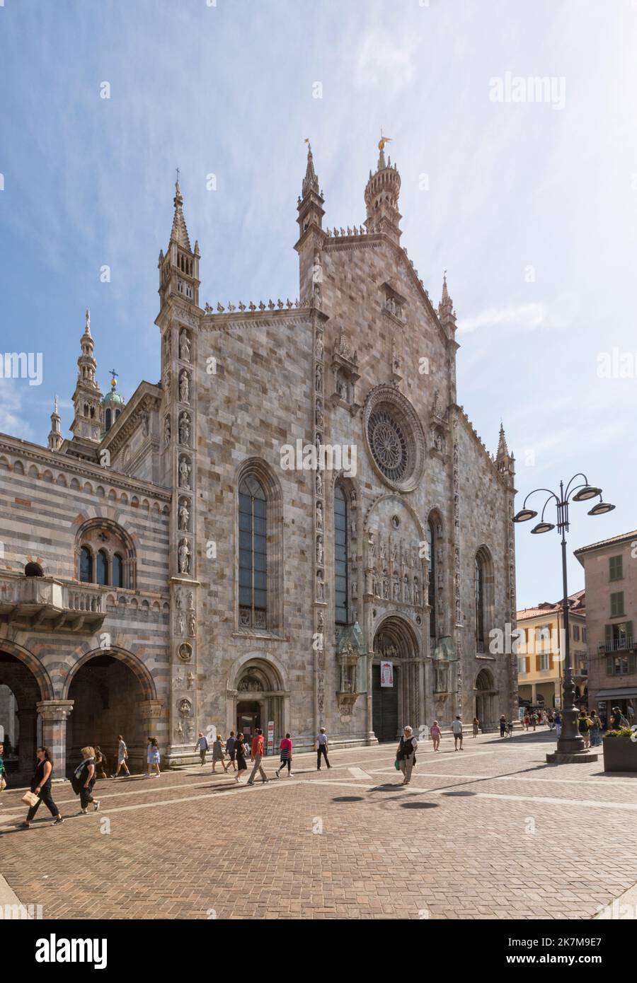 Main facade of the gothic style Cathedral on a sunny day. People on the square in front. Stock Photo