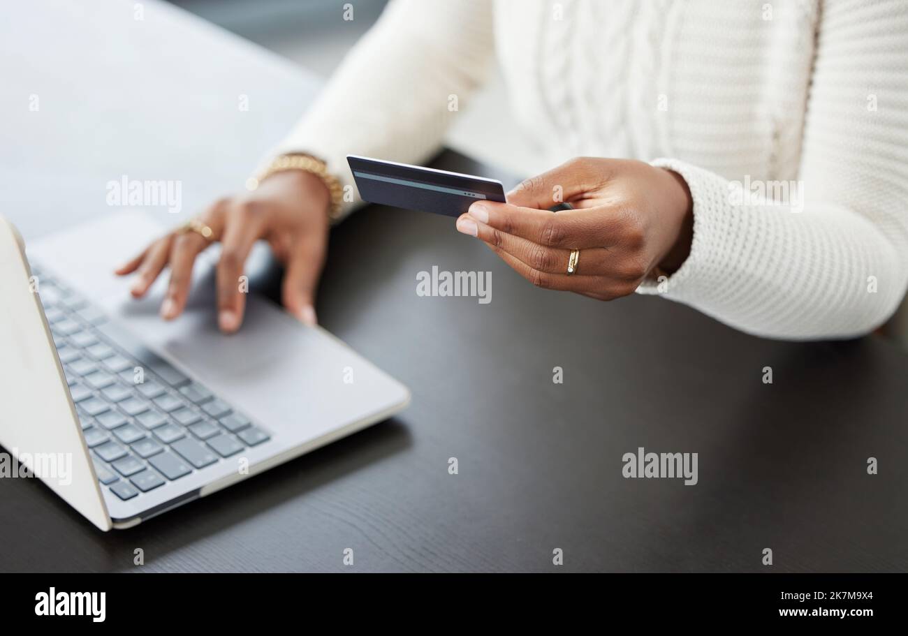 I am my own personal banker. a woman using her laptop to make online card payments. Stock Photo