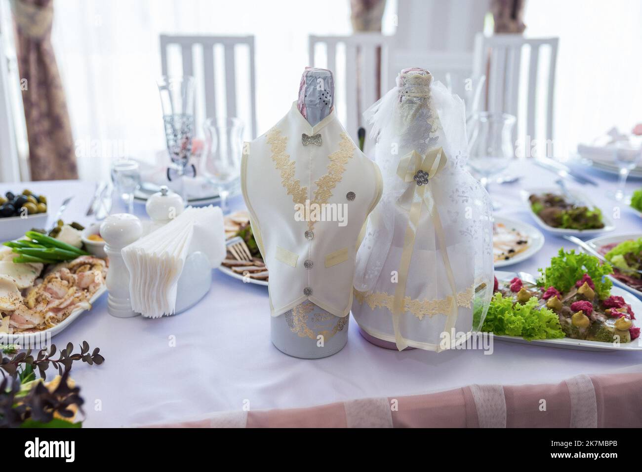 Bottle of champagne in bucket with ice and glasses on blurred background, closeup. bottles of champagne at the wedding on the table Stock Photo