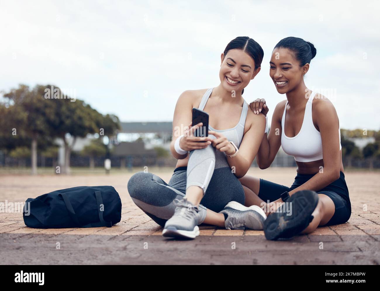Friends, fitness and phone app with women on internet happy about social media, motivation message or exercise goal. Female runner and athlete with Stock Photo
