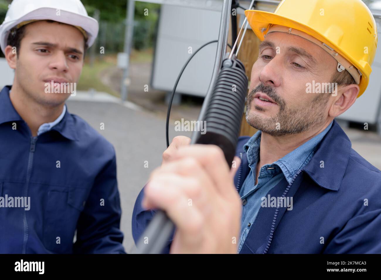two technicians installing an equipment Stock Photo