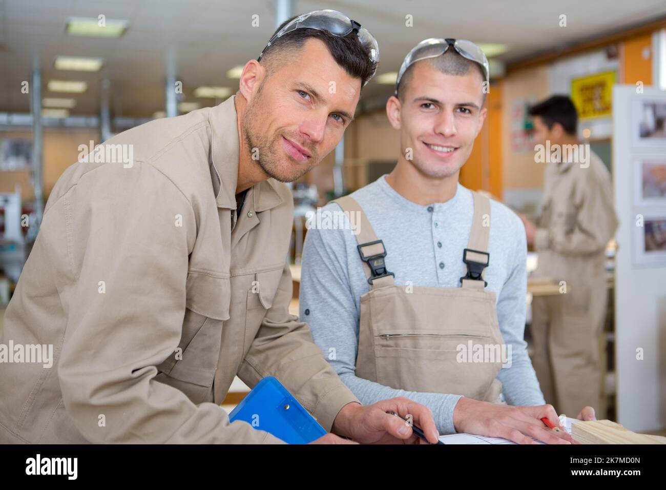 industrial apprentice posing with trainer Stock Photo - Alamy