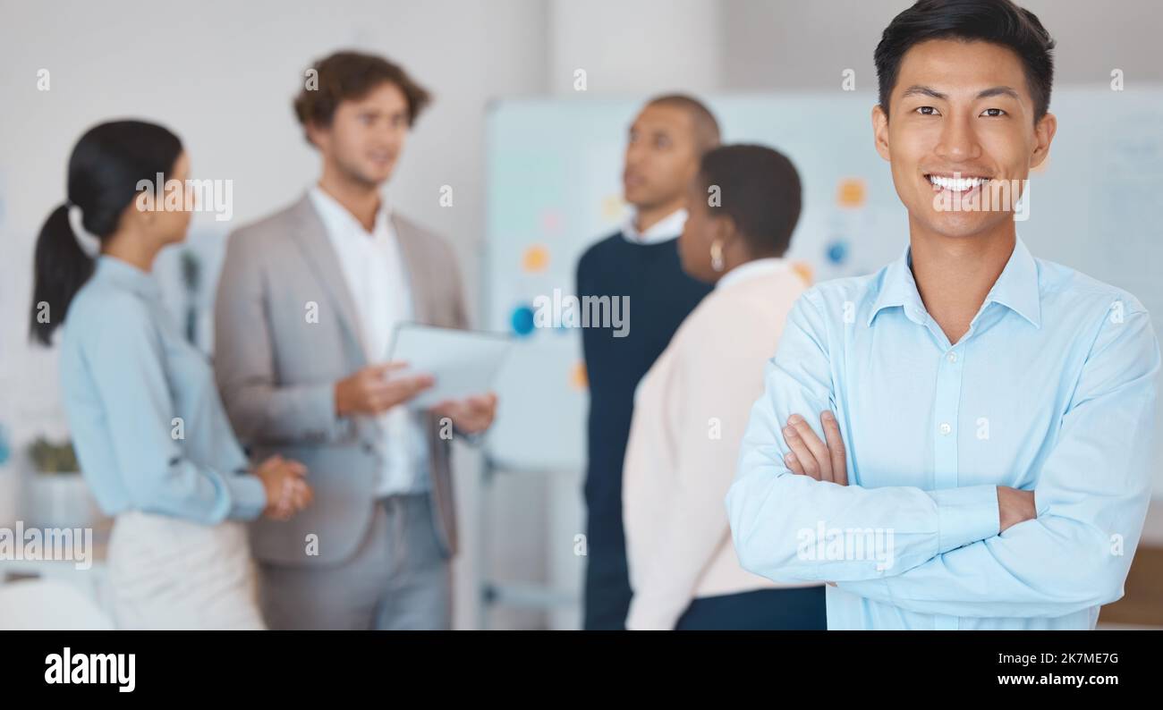 Leadership, motivation or happy Asian businessman leader in meeting for diversity, teamwork or team building with smile. Happy employee, manager or Stock Photo