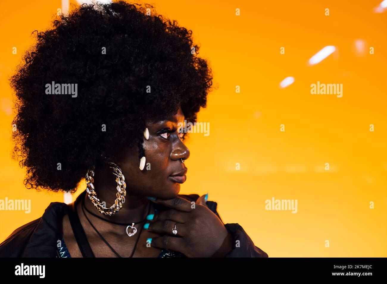 African woman's face with yellow light and traditional African hair Stock Photo