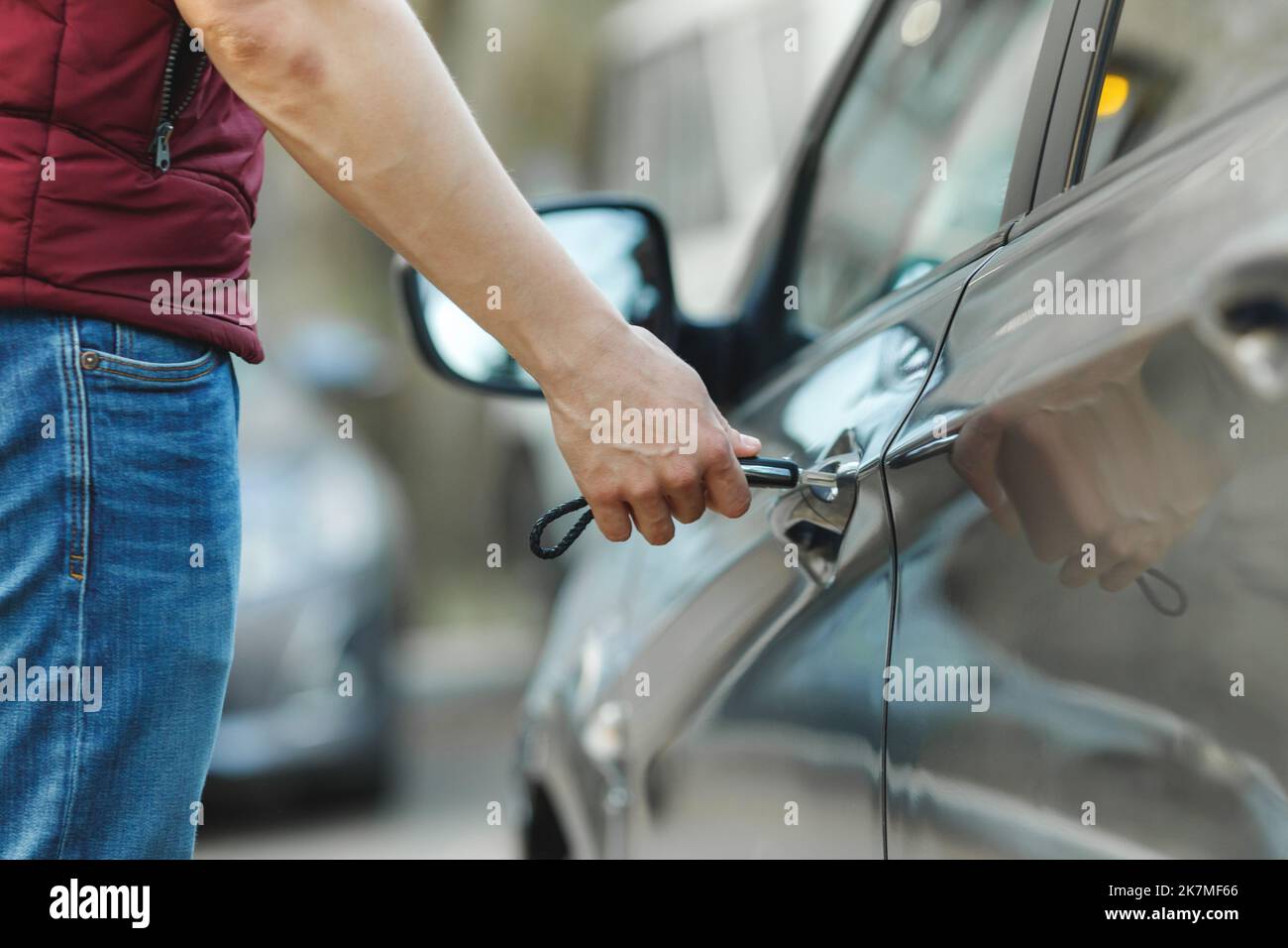 A man opens a car door with a key. Dead battery in remote key Stock