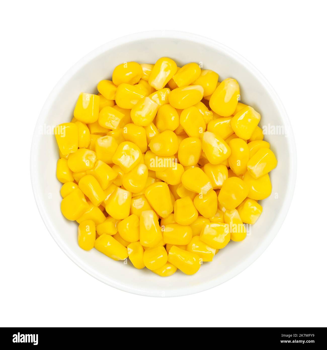 Sweet corn kernels, in a white bowl over white. Cooked canned yellow vegetable maize, Zea mays, also called sugar or pole corn. Stock Photo