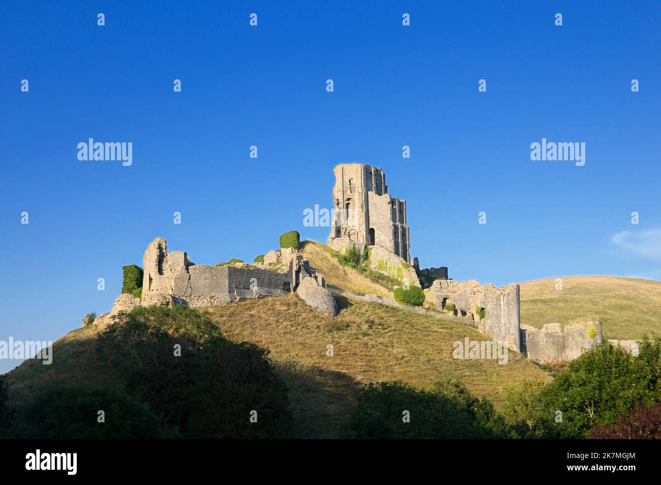 Looking up at the 11th century hilltop ruins of Corfe Castle in sunshine, Isle of Purbeck, Dorset, England, UK Stock Photo