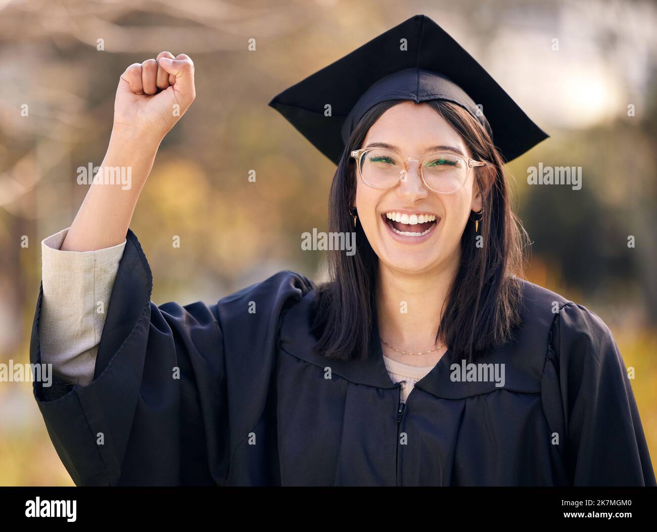 Now go fourth and conquer. a young woman cheering on graduation day. Stock Photo