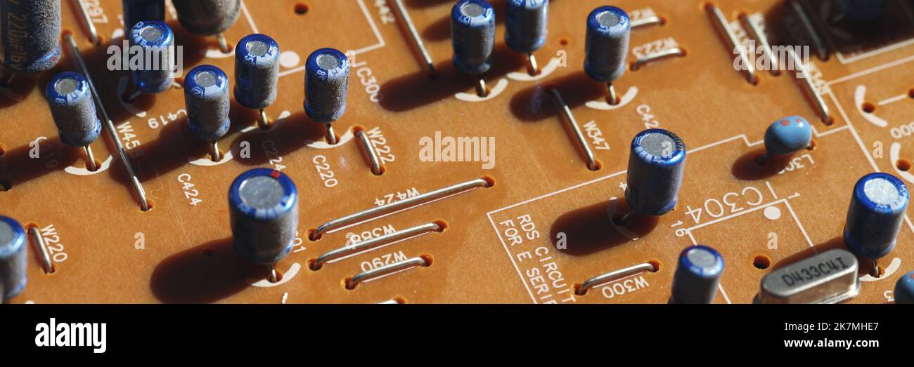 Printed circuit board with capacitors, close up panoramic photo with selective soft focus Stock Photo