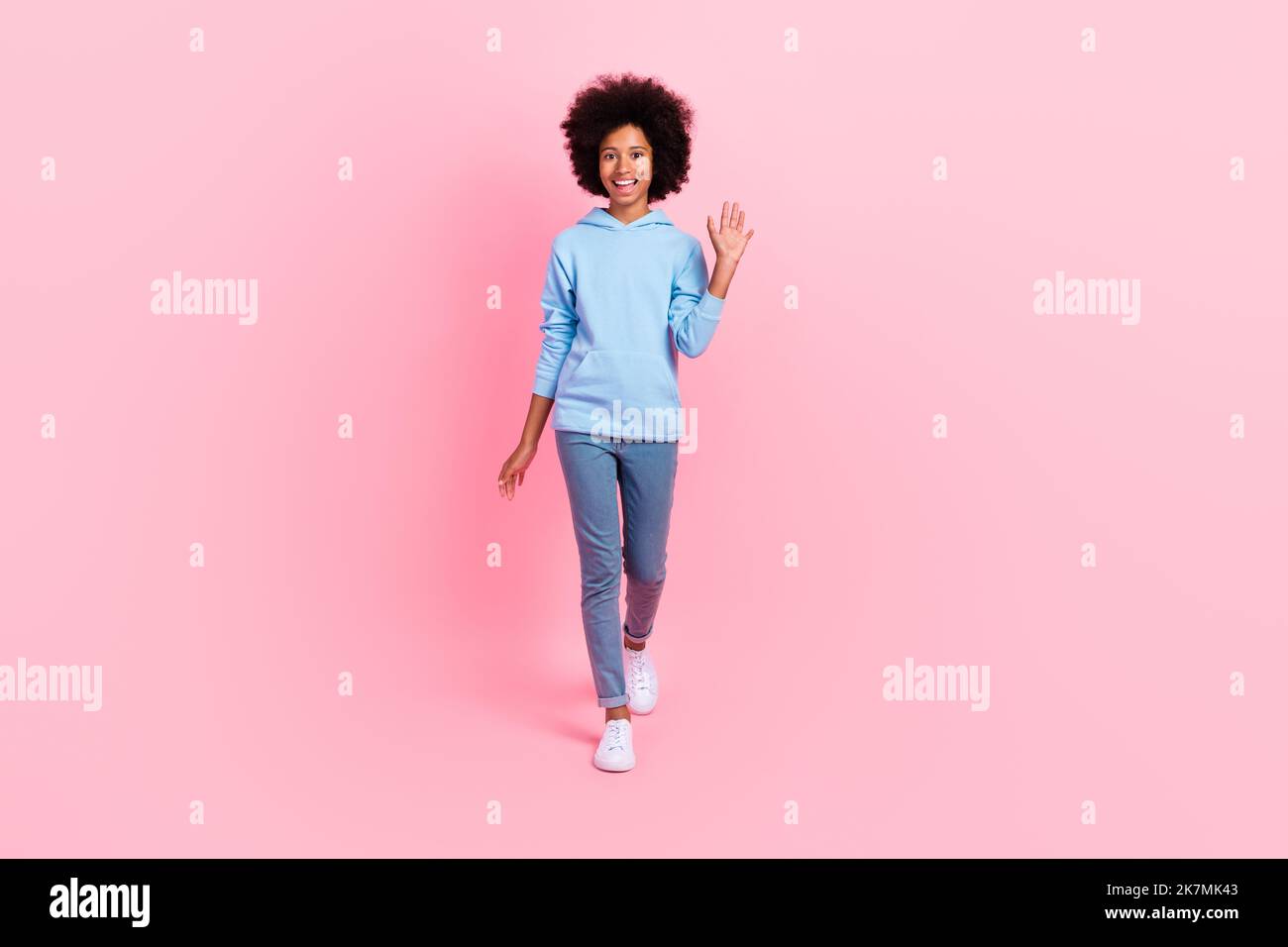 Full length photo of cheerful positive person walking arm palm waving ...