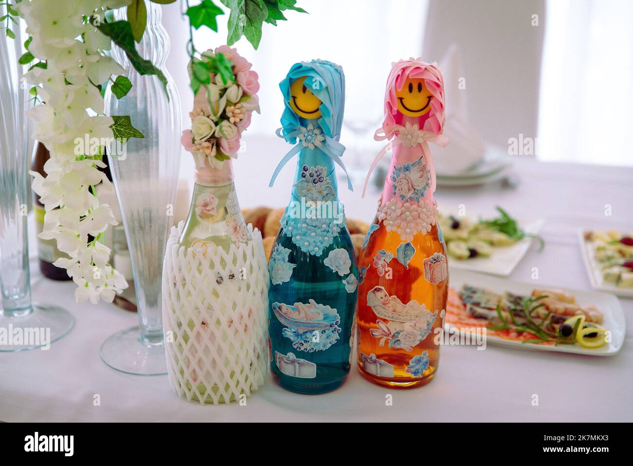 Bottle of champagne in bucket with ice and glasses on blurred background, closeup. bottles of champagne at the wedding on the table Stock Photo