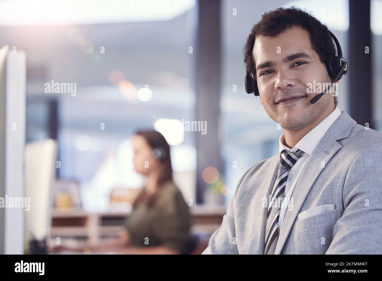 Dedicating to improving the lives of others. a young male call center agent at work. Stock Photo