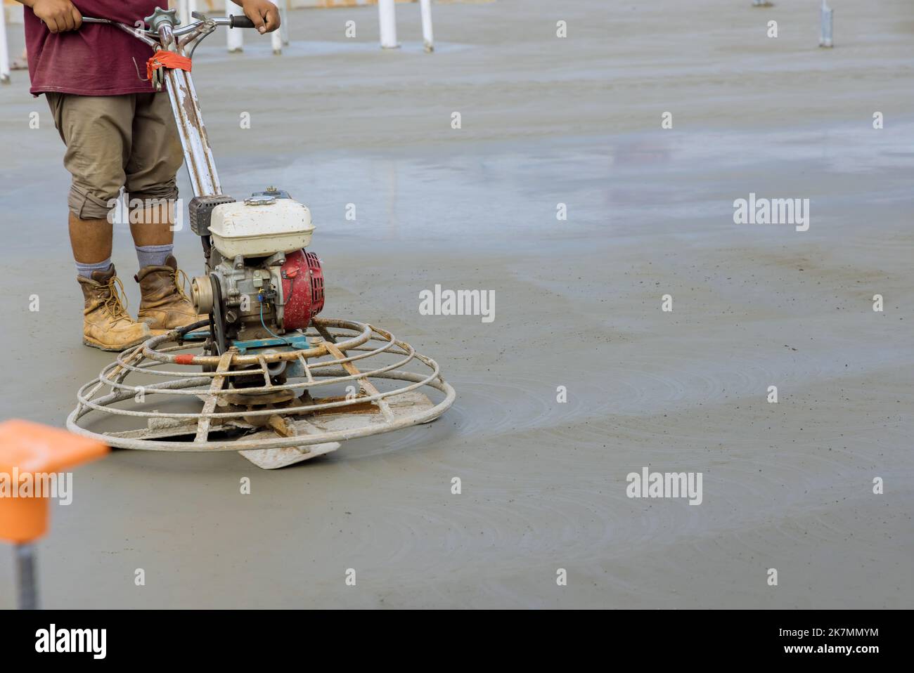 Polishing and leveling cement screed mortar floor on construction site is craftsman performing Stock Photo