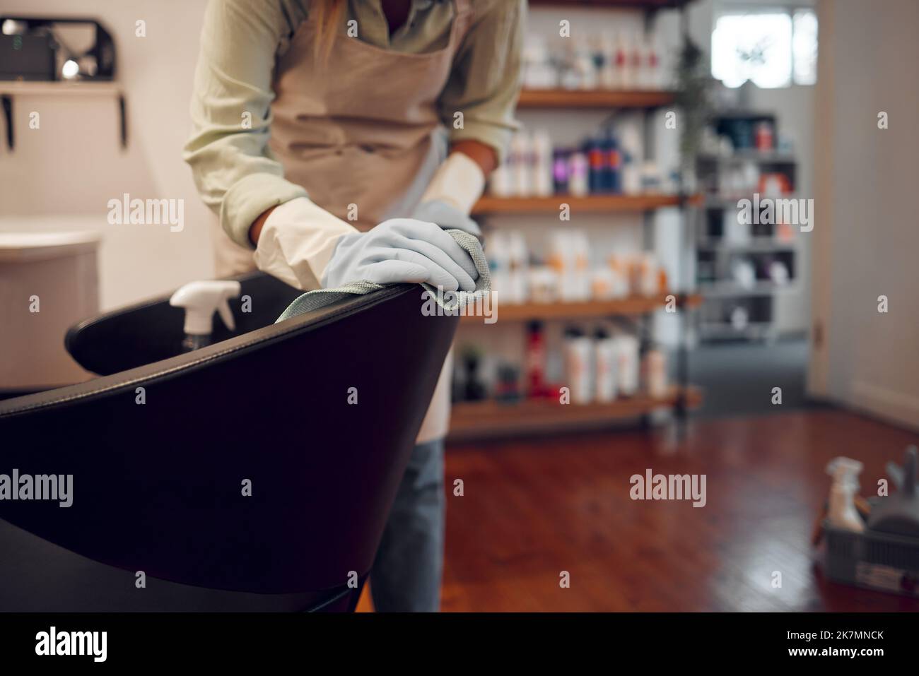 Salon, small business and woman cleaning chair with equipment in modern