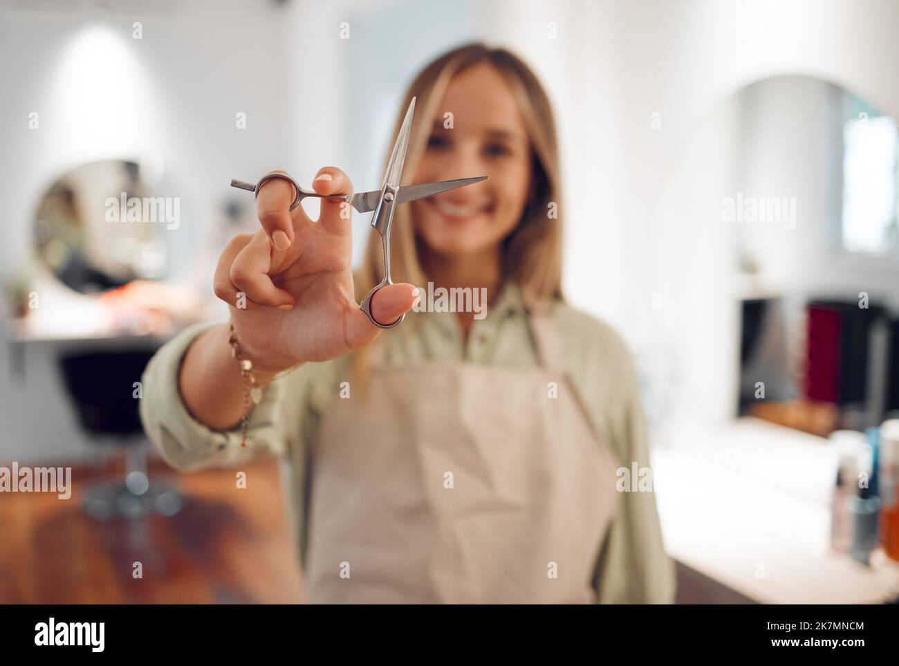Hand, scissors and haircut with a woman hairdresser ready to cut or