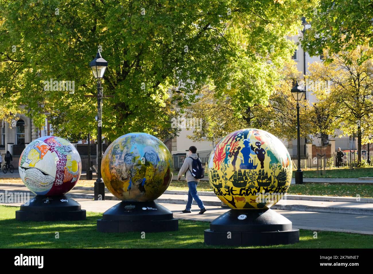 Bristol, UK. 18th Oct, 2022. On a sunny day in Bristol amongst autumnal trees, the Globes of the World Reimagined art trail has been gathered on College Green. World Reimagined is a learning program to educate young people about racial injustice, the Globes will remain on college green throughout the rest of Black History Month. Credit: JMF News/Alamy Live News Stock Photo