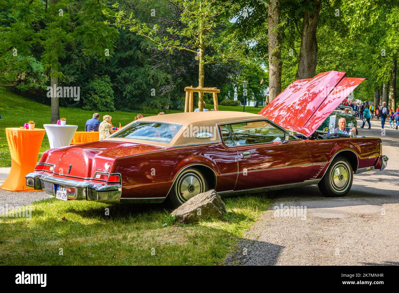 BADEN BADEN, GERMANY - JULY 2019: red maroon LINCOLN CONTINENTAL MARK IV full-size cabrio car 1972 1976 with opened hood, oldtimer meeting in Kurpark. Stock Photo