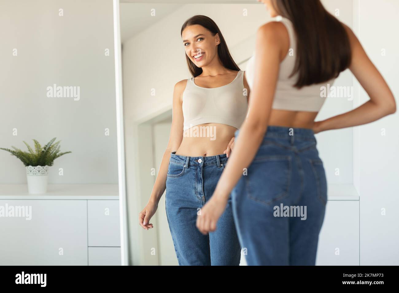 Woman looking body shape mirror hi-res stock photography and images - Alamy