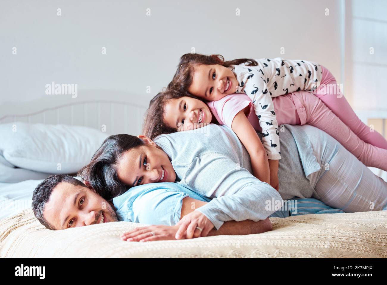 A father is the backbone of the family. a young family lying on top of