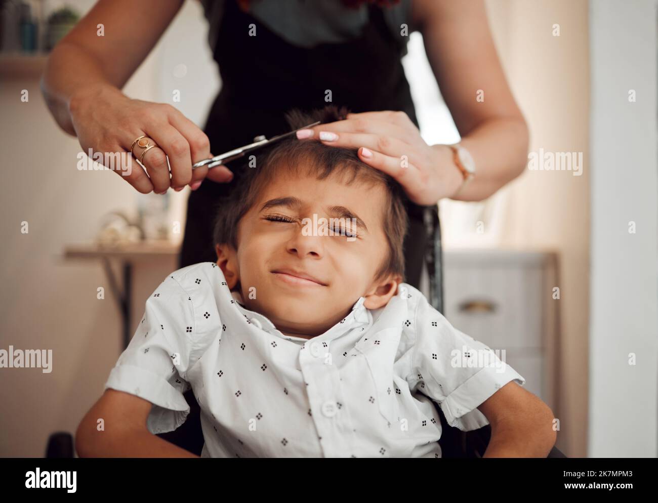 Disability child, hair cut and hands of hairdresser trim, groom and