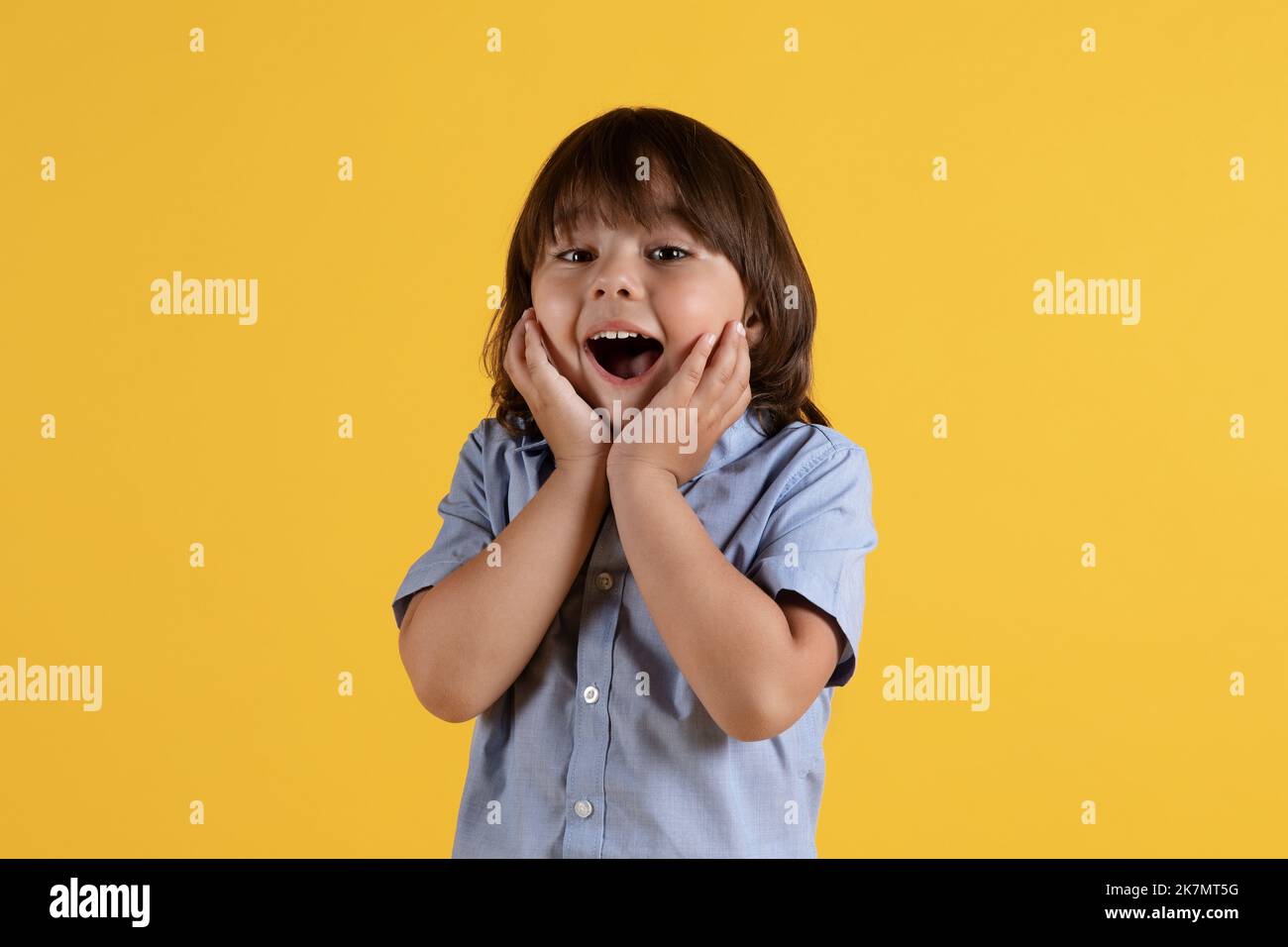 Excited kids face. Amazed expression, cheerful and glad. Amazed child with  open mouth on yellow background, surprise Stock Photo - Alamy