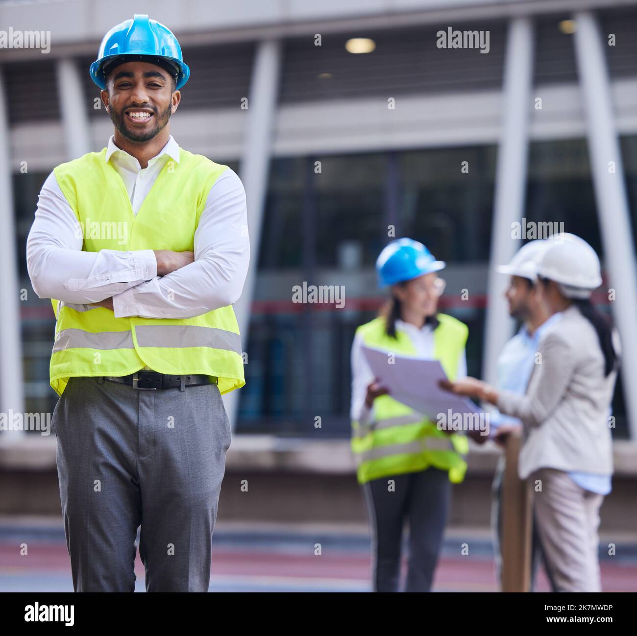 My team will find a solution. a handsome young architect standing with