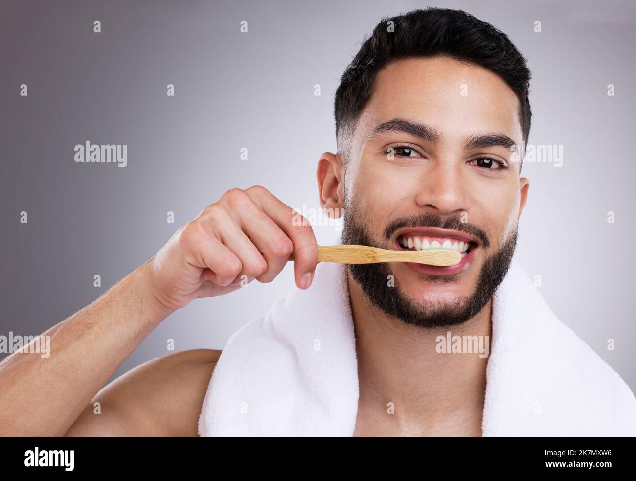 Make those pearly whites shine. a handsome young man brushing his teeth